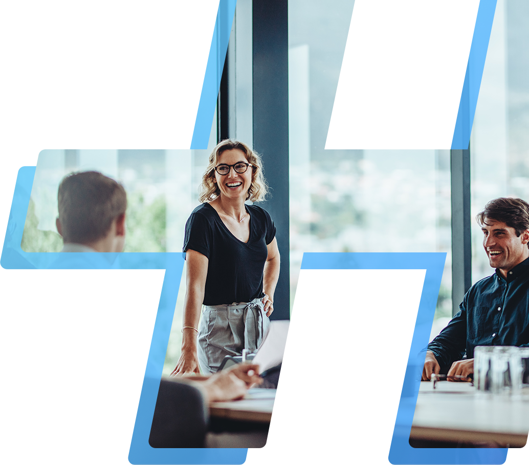 Woman standing in front of large windows leading group discussion